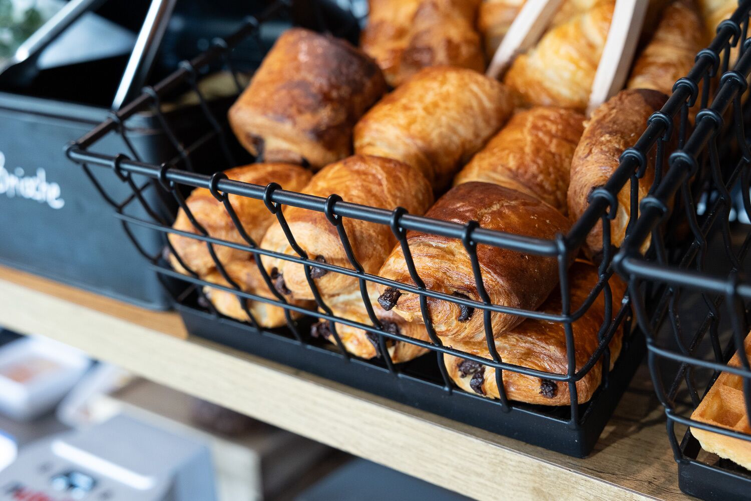 A basket of pastries on a counter.
