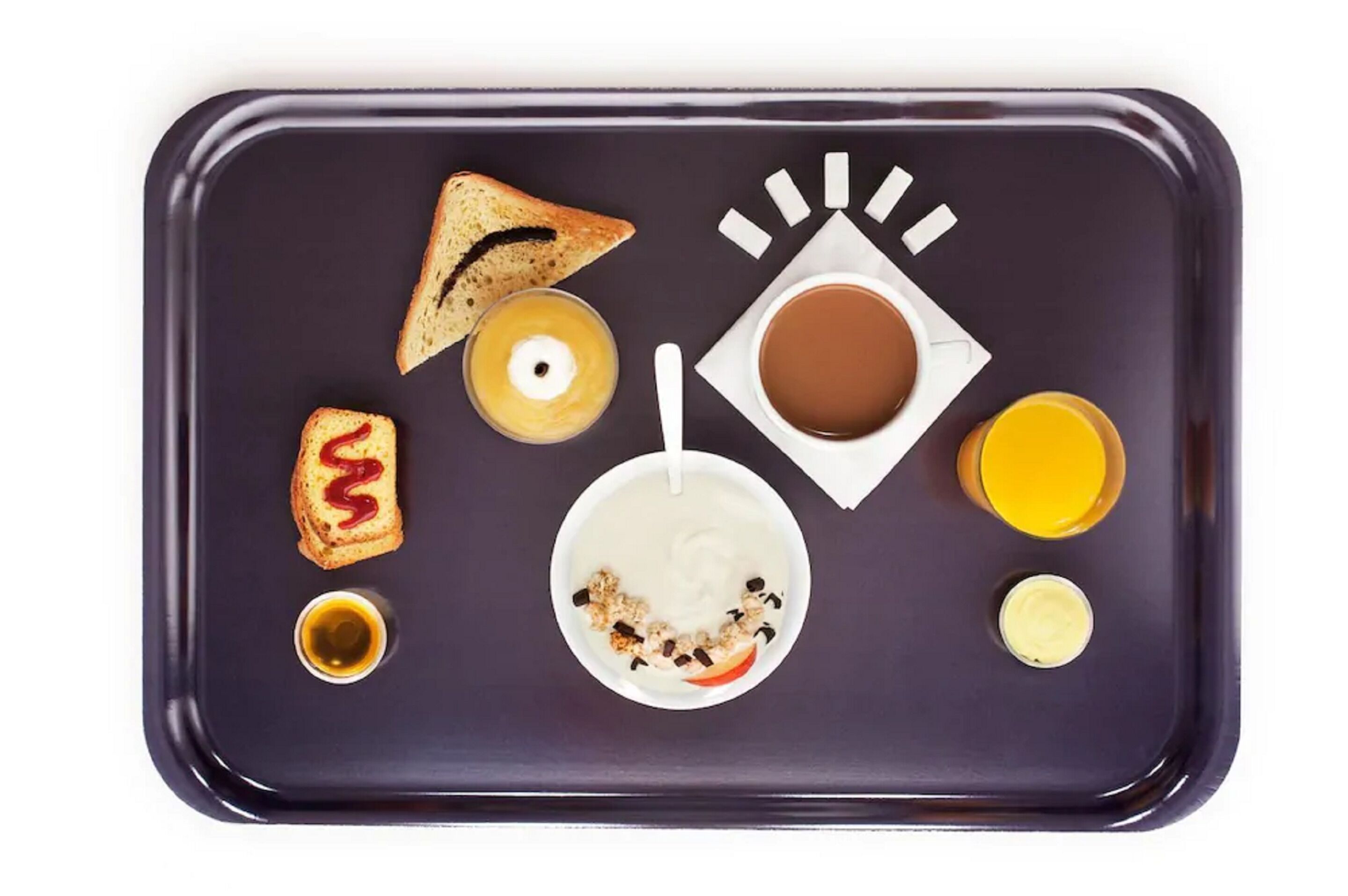 A tray with toast, jam, yogurt, a cup of coffee, and a glass of juice.