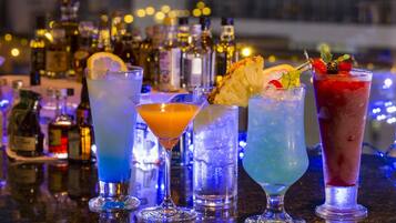 A bar with various cocktails and bottles of liquor.