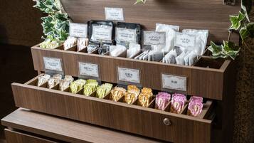 A wooden display case with various toiletries and personal care items, including face masks, shower caps, and hairbands.
