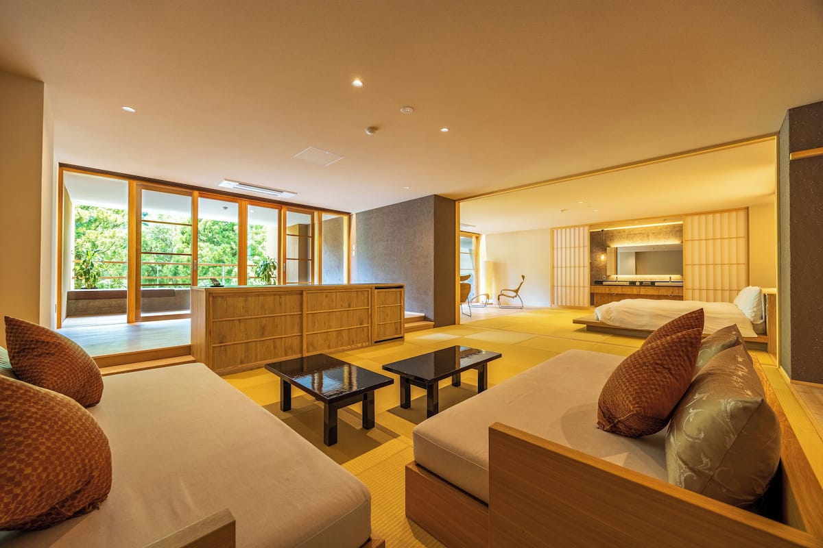 A modern living room with a sofa, coffee table, and a TV area.