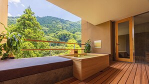 A wooden deck with a hot tub, potted plants, and a view of a forested hillside. - Kinnotake Tonosawa - Adult Only (Hakone)