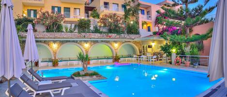 Seasonal outdoor pool, open 10:00 AM to 6:00 PM, pool umbrellas