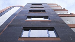 A modern building with a series of rectangular windows and a curved architectural feature on the left. - Nova Hotel Yerevan (Yerevan)