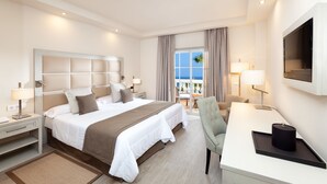 A hotel room with a large bed, a desk, a chair, and a TV. - Hotel Riu Garoé (Puerto de la Cruz)