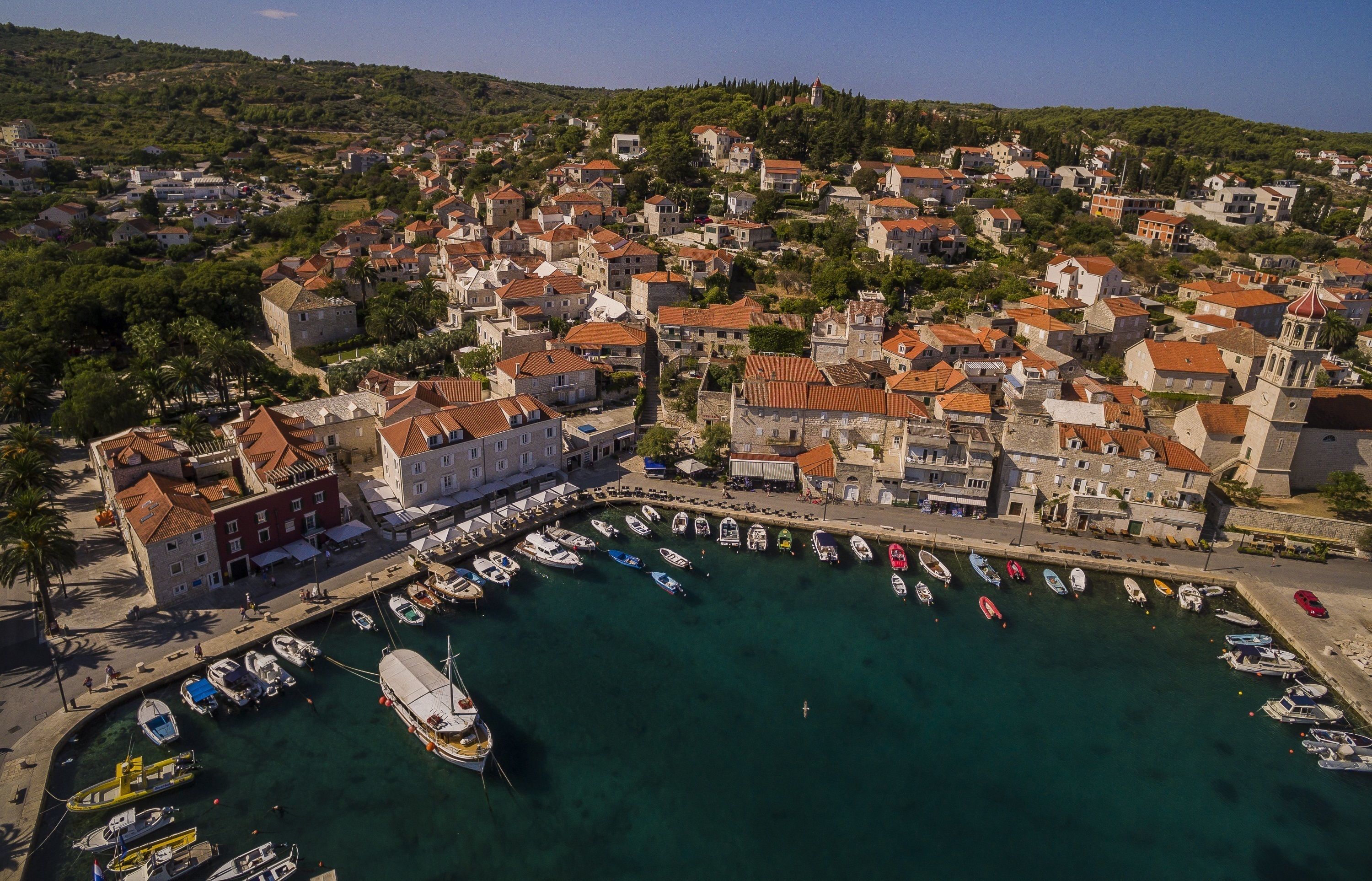 A coastal town with a marina, historic buildings, and a prominent church.