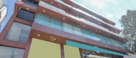 A multi-story building with large windows and a modern architectural design.