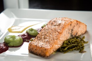 A plate with salmon, green sauce, and green vegetables. - Best Western Lancaster Morecambe Lothersdale Hotel (Morecambe)
