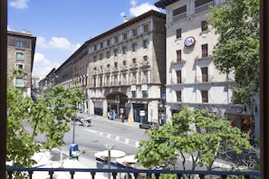 A street view with buildings, a clear sky, and trees.