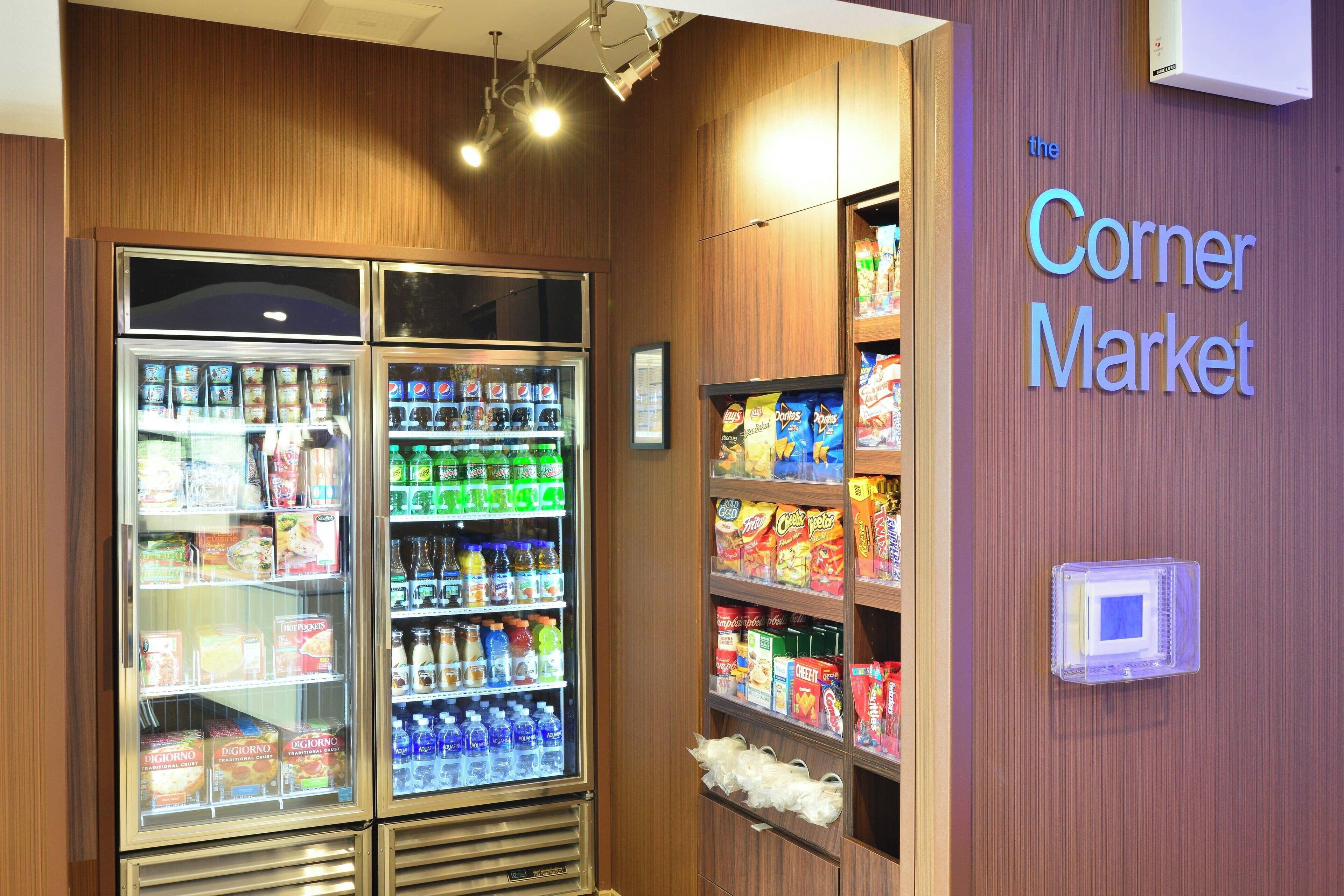 A refrigerated display case with various food items and beverages.