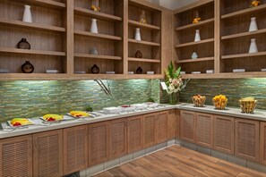 A modern kitchen with wooden cabinets, a glass-top counter, and a tiled backsplash. - Hyatt House at Anaheim Resort/Convention Center (Anaheim)
