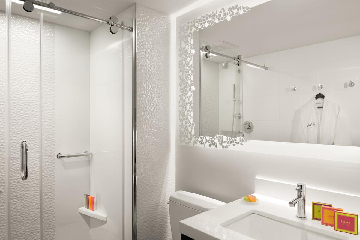 designer toiletries, hair dryer, bathrobes, slippers