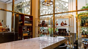 A bar area with marble countertops and shelves of liquor bottles. - Waldorf Astoria Washington DC (Washington)