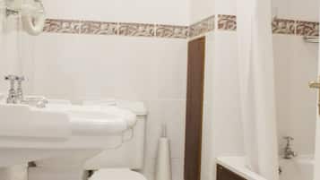 A bathroom with a sink, toilet, and bathtub.