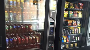 Two beverage vending machines with a variety of drinks and snacks. - Crown Inn (Toledo)