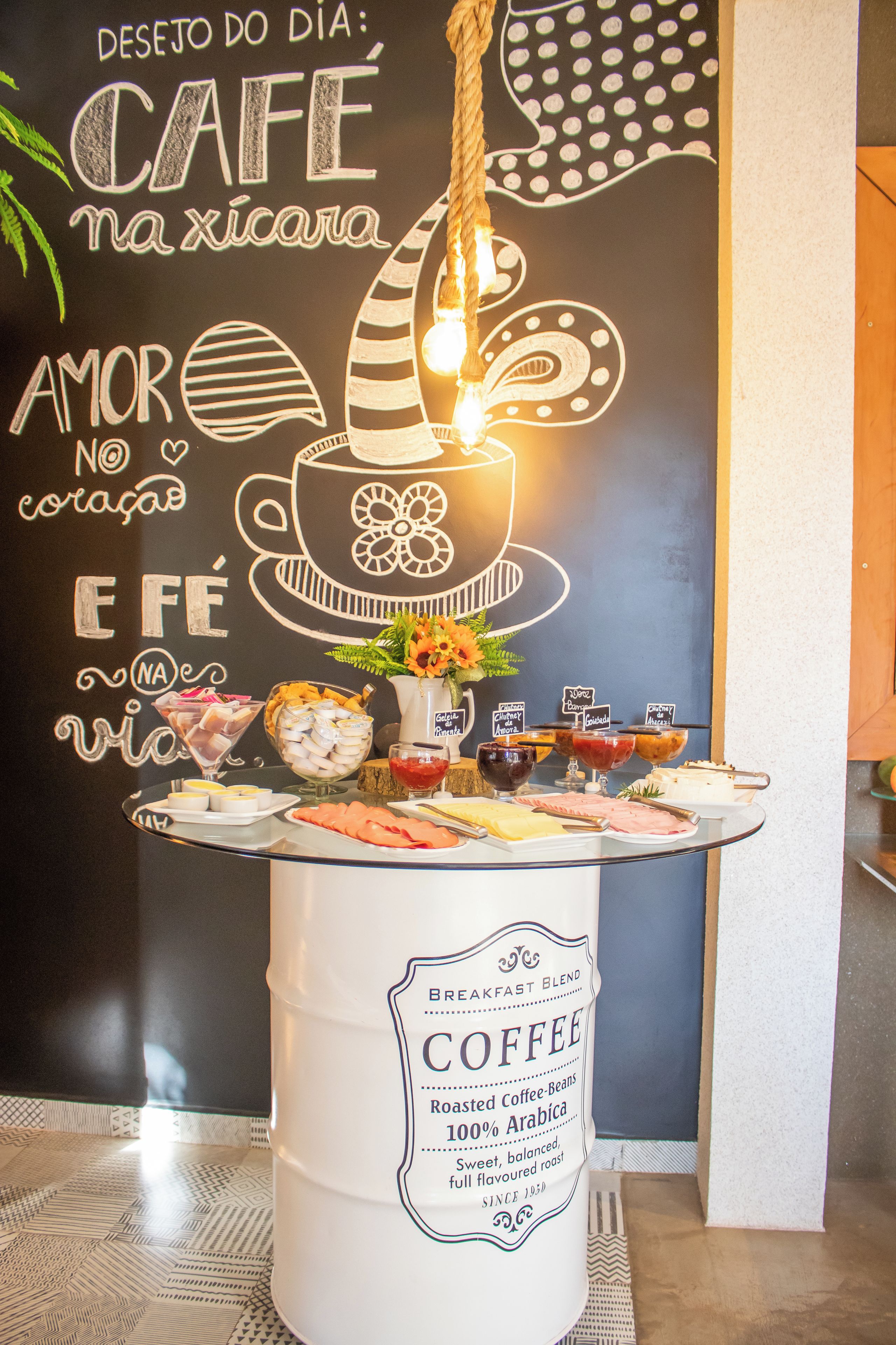 A breakfast buffet with a coffee station and a chalkboard with text and drawings.