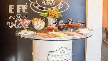 A breakfast buffet with a coffee station and a chalkboard with text and drawings.