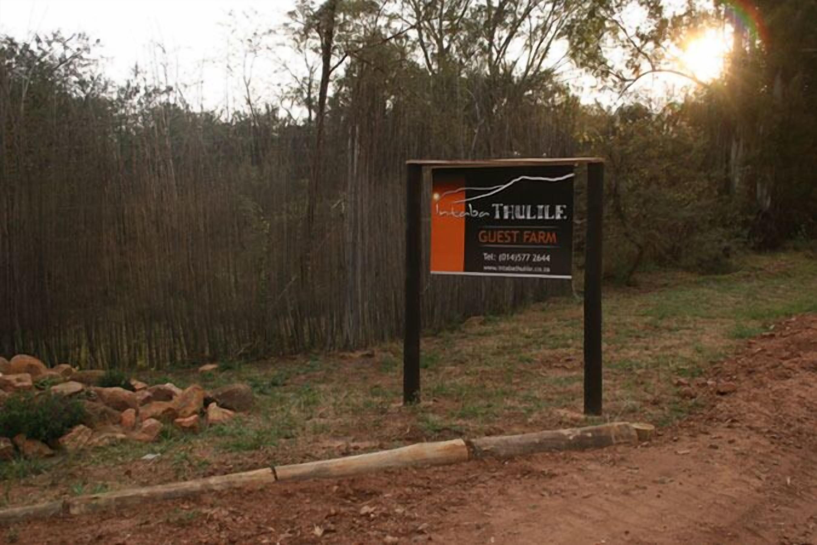 A sign for Intaboon Thulile Guest Farm with contact information.