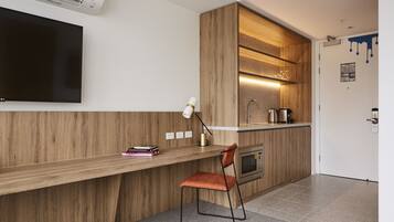 A modern kitchen with a wooden countertop, a built-in oven, and a sink.