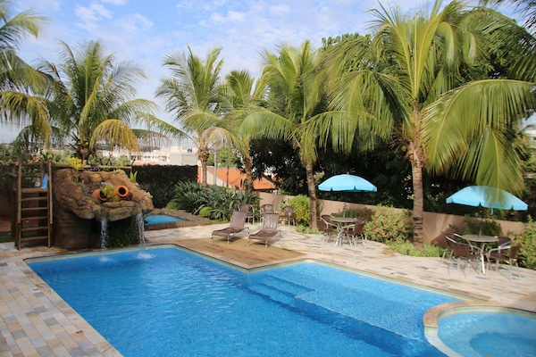 Outdoor pool, open 9:00 AM to 9:00 PM, pool umbrellas, pool loungers