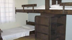 Une chambre avec un lit simple et un lit superposé.