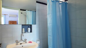 A bathroom with a sink, mirror, and shower curtain. - Summer House Louisa (Lefkada)