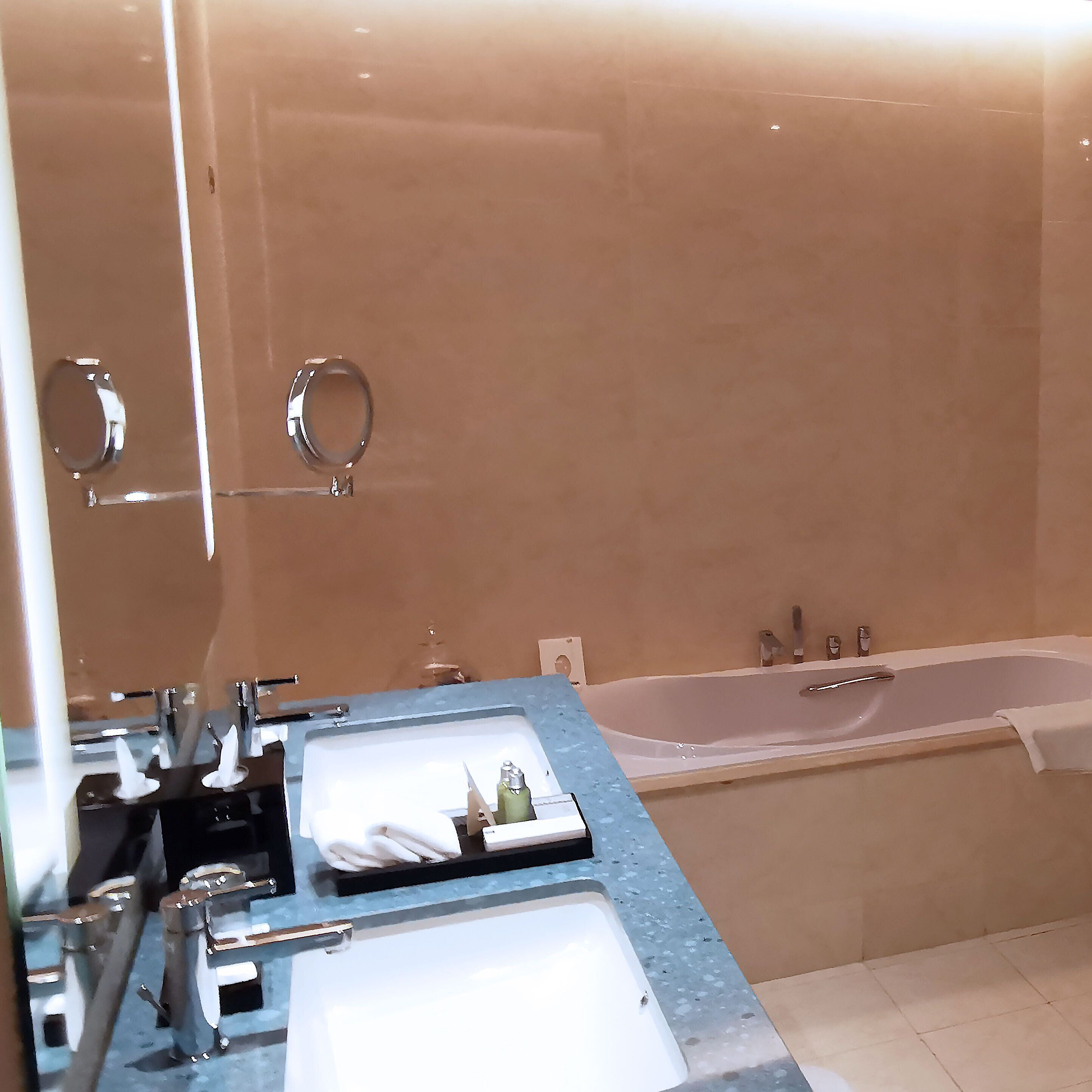 A bathroom with a bathtub, a sink, and a mirror.