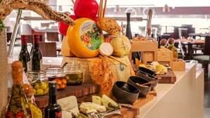 A buffet table with various cheeses, bread, and condiments. - Rosh Olaya Hotel (Riyadh)