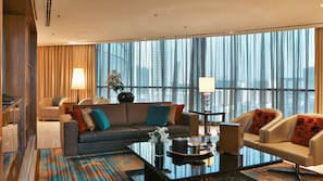 A modern hotel room with a large window, a sofa, a coffee table, and a chair. - Rosh Olaya Hotel (Riyadh)