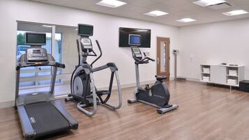 A fitness center with treadmills, elliptical machines, and a stationary bike.