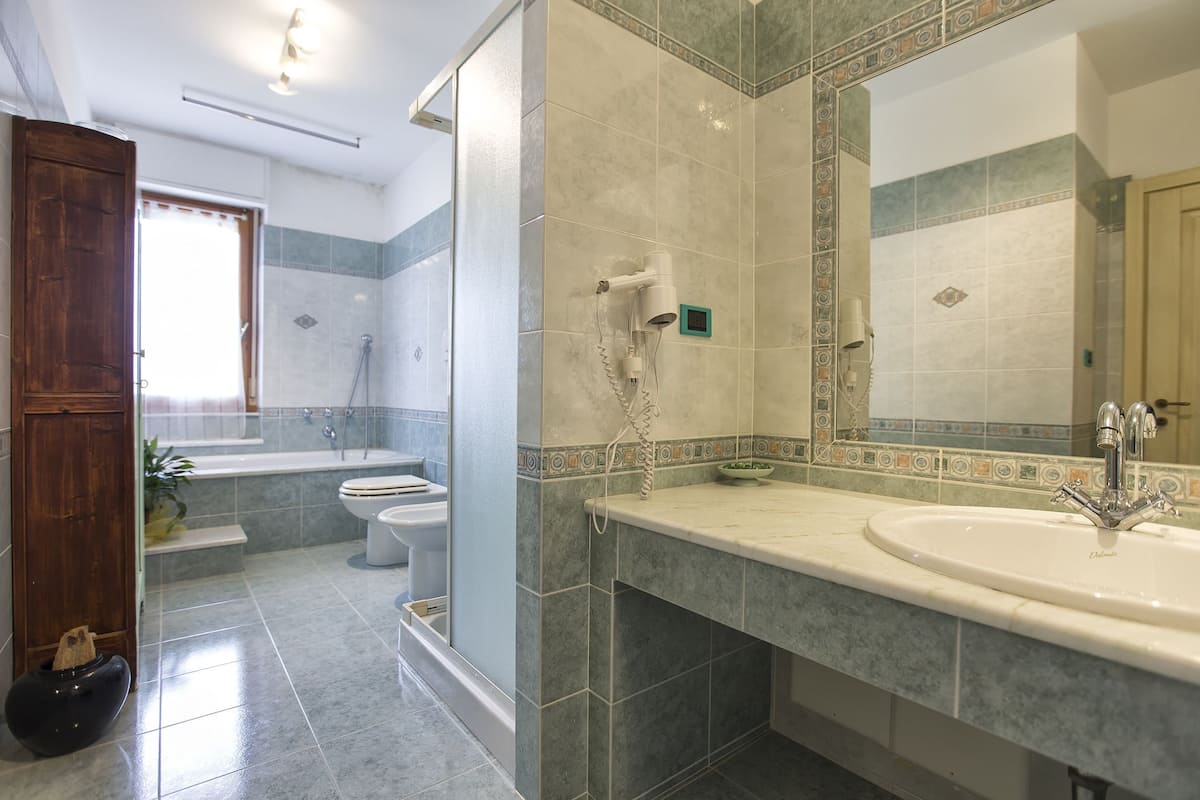 A bathroom with a bathtub, toilet, and sink.