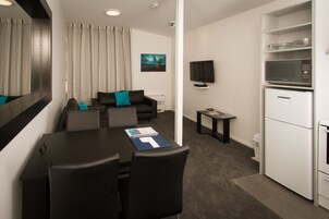 Premier Suite, 2 Bedrooms | Living room | Flat-screen TV, DVD player