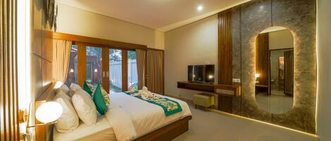 A modern bedroom with a large bed, a TV, and a mirror.