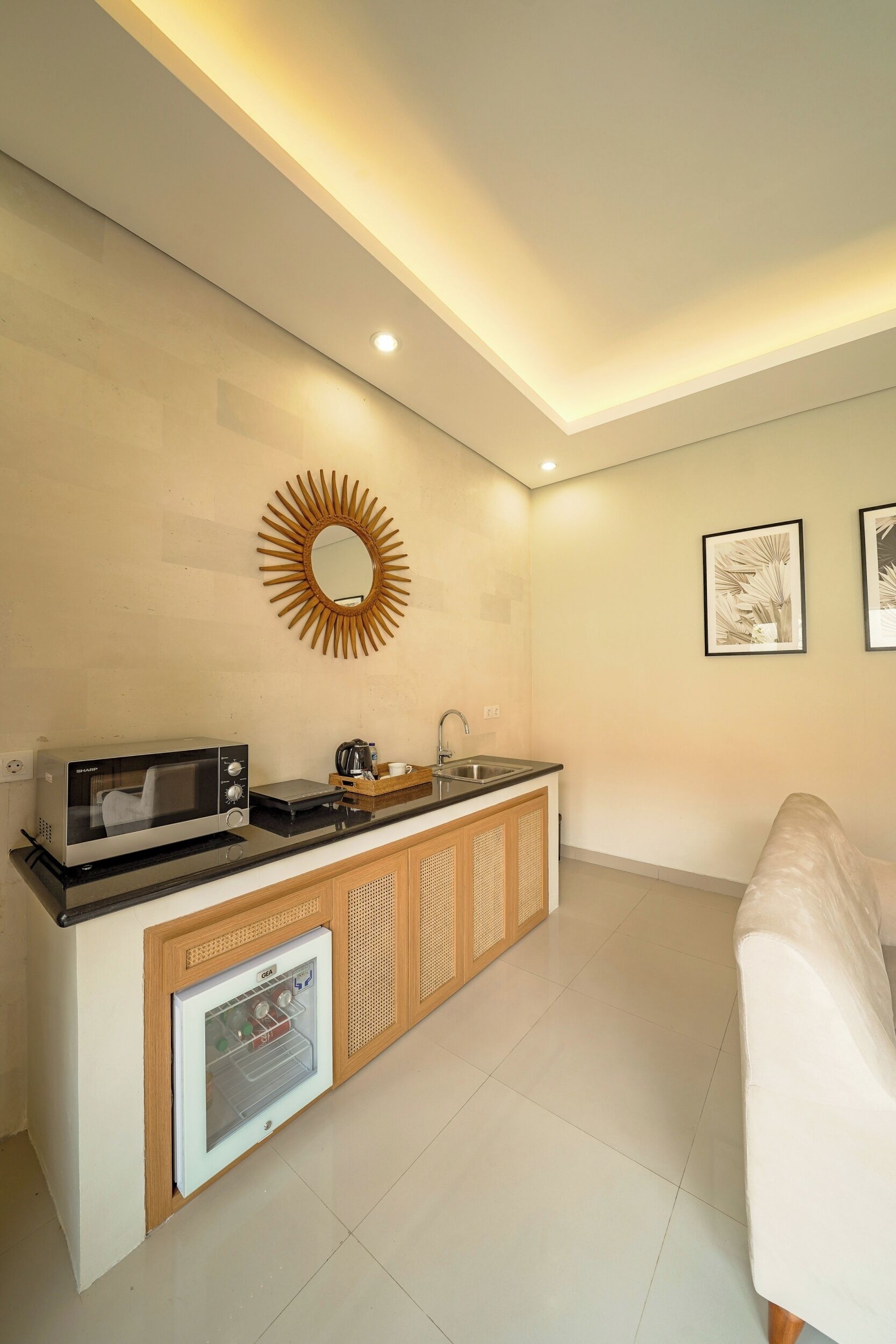 A modern kitchen with a microwave, coffee maker, and refrigerator.