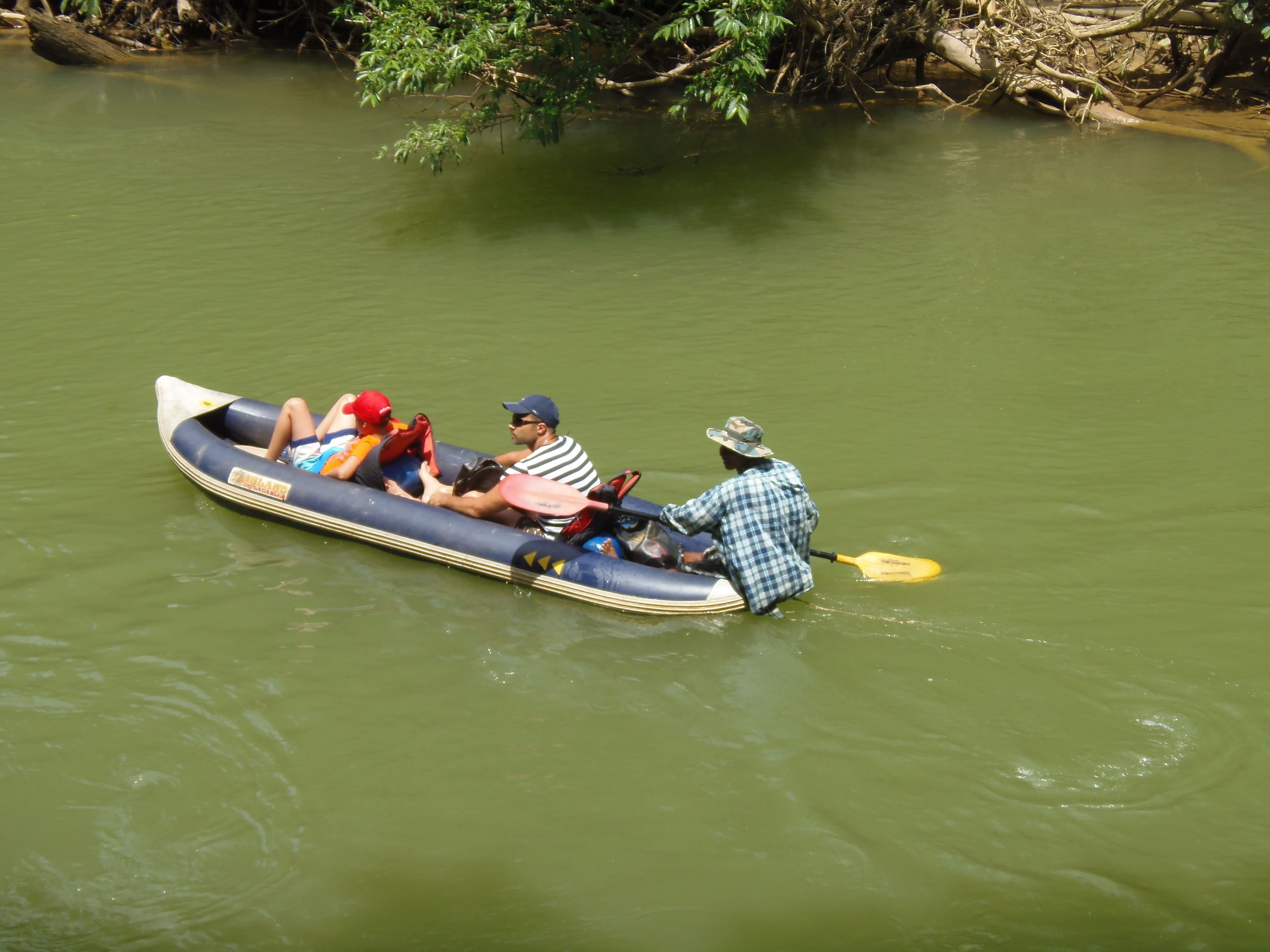 A group of people in a raft on a river.