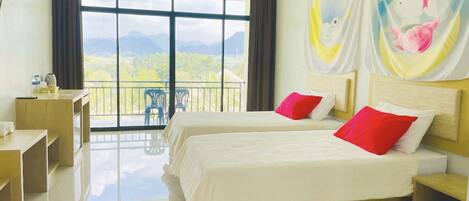 A hotel room with two beds, a balcony with a view of mountains, and a painting on the wall.