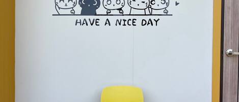 A door with a cheerful wall decal of four cats and the text "HAVE A NICE DAY".