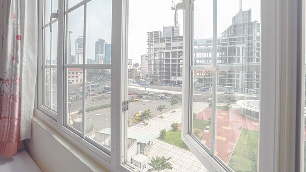 A view from a window with a view of a cityscape, including buildings and a road. - Song Anh 3 Hotel (Ho Chi Minh City)