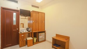 A compact room with a wooden wardrobe, a small kitchenette, and a seating area. - Song Anh 3 Hotel (Ho Chi Minh City)
