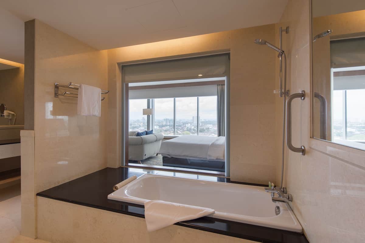 premium suite, 1 king bed, bathtub | bathroom | shower, free toiletries, hair dryer, slippers