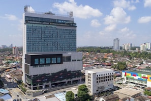A modern high-rise building with a glass facade and a flat roof.
