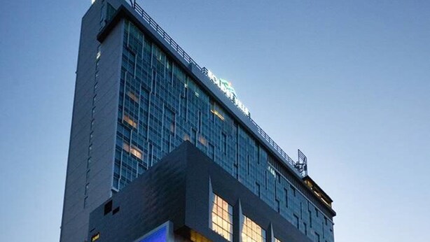 A modern building with a prominent sign for "Baulart Tuanku" and a large illuminated logo. - Holiday Villa Johor Bahru City Centre (Johor Bahru)