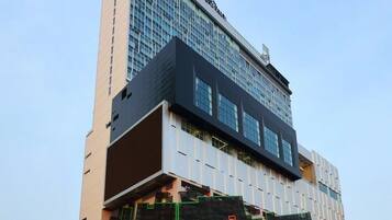 A modern hotel with a unique architectural design, featuring a large glass facade and a prominent black and white color scheme.