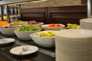 A buffet with various dishes including salads, fruits, and vegetables. - Tolip Inn Maadi (Cairo)