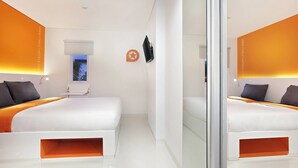 A modern hotel room with two beds, a TV, and a window with a view. - Starlet Hotel Serpong (South Tangerang)