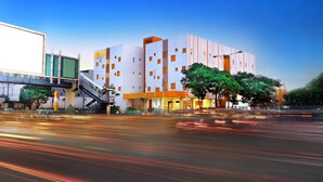 A modern hotel with a multi-story structure, a covered entrance, and a staircase leading to the entrance. - Starlet Hotel Serpong (South Tangerang)