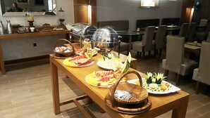 A buffet table with various dishes and a coffee station. - The Seven Hotel and Spa (Casablanca)