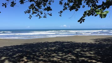 On the beach, black sand, beach towels