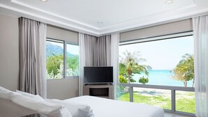 A modern hotel room with a large bed, a flat-screen TV, and a view of the ocean. - PP Princess Pool Villa (Ko Phi Phi)