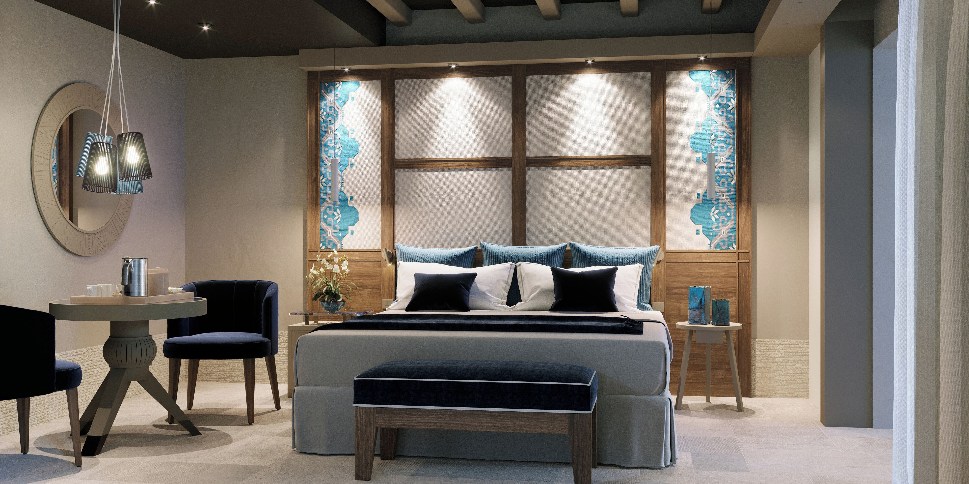 A modern bedroom with a large bed, a round table, two chairs, a bench, and a nightstand with a lamp.